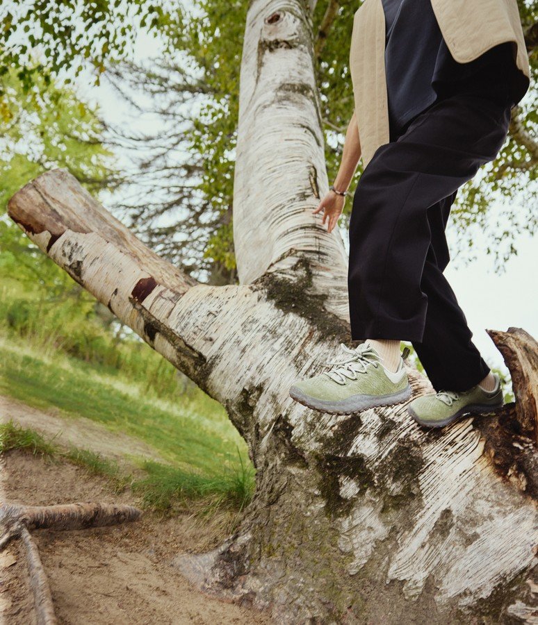 Person walking along a fallen birch trunk in Merrell barefoot shoes